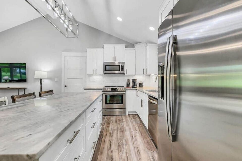 Stocked kitchen with drip coffee pot, small crock pot, mixer