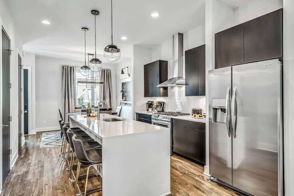 Enjoy cooking in a sleek kitchen with comfortable seating and abundant natural light