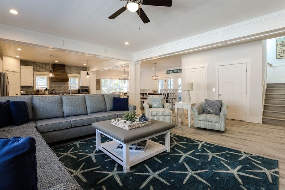 Family room view towards kitchen and dining room; Elevator next to stairway 