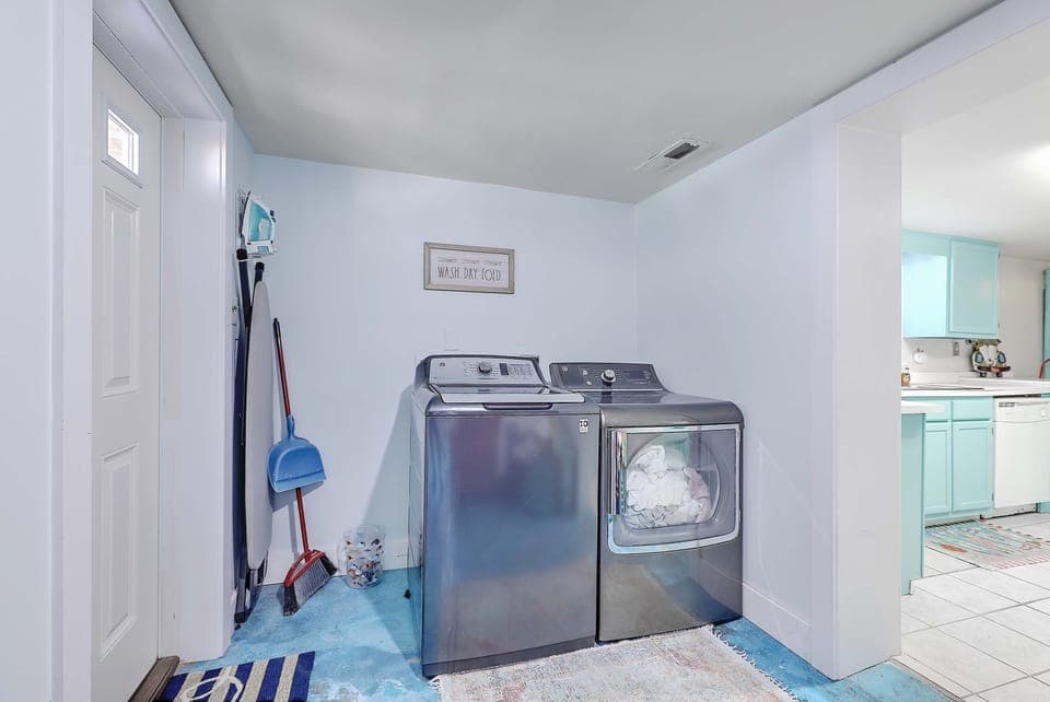 Upstairs foyer/ stairs lead down to laundry, kitchen, pool table, den,  BRs & BA