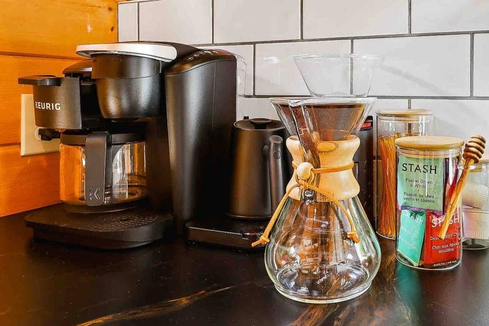 A coffee lover's dream. Fully stocked with a Chemex pour-over, Bodum Burr Grinder, Electric Water Kettle, and Keurig Drip/Pod combo machine - the caffeine corner comes pre-stocked with a selection of coffee pods and Stash Tea samples. 