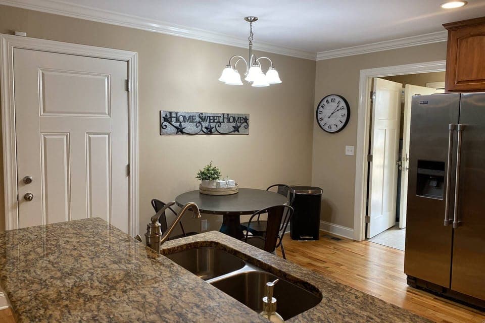 Dining table seats 4, with additional 3 stools at the kitchen island