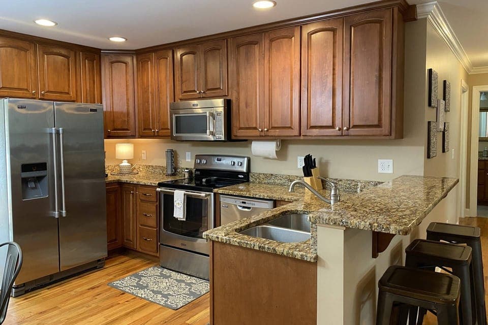 Fully stocked kitchen has ample dishes, glasses, silverware, bowls, pots and pans for quick food on the run or full meals.