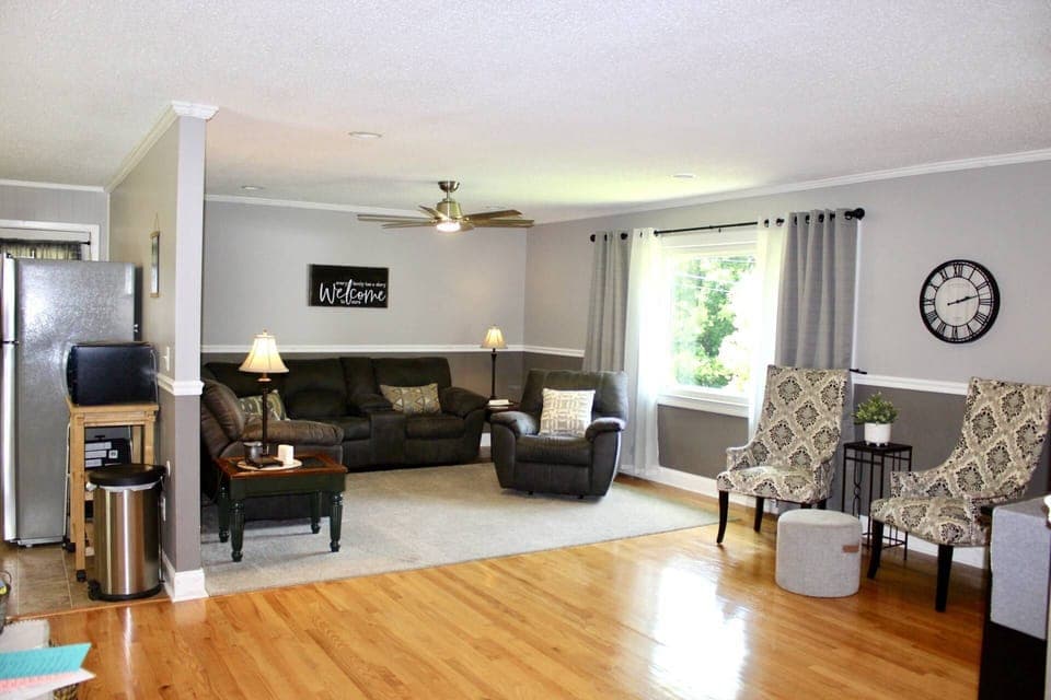 Spacious living room with ample seating that is open to kitchen and dining.