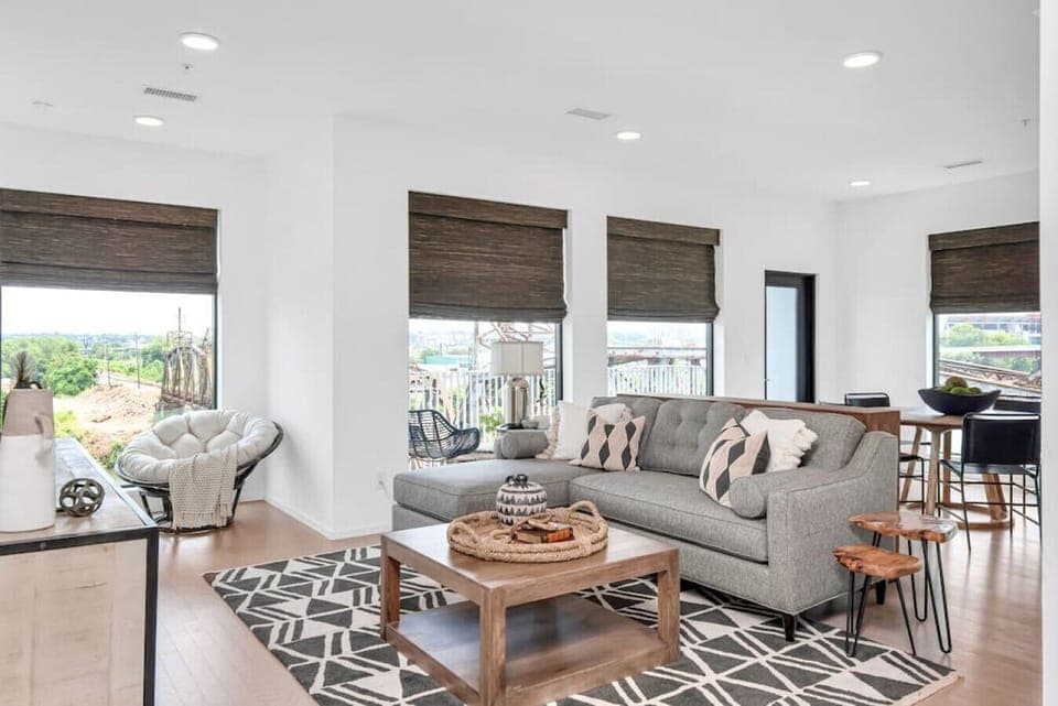 Bright and spacious living room that opens to the kitchen. The couch turns into a sleeper sofa. Custom blackout blinds. Smart TV equipped with YouTube TV for cable.