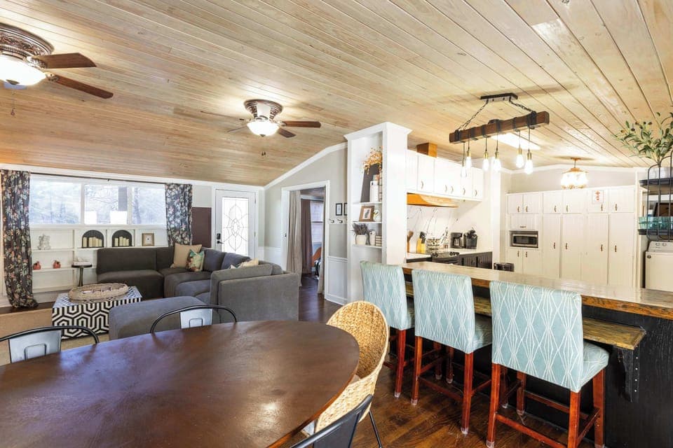 The living room extends into the kitchen and dining area which also leads to the pool and sitting areas outside. There are lots of places for the entire group to spread out!