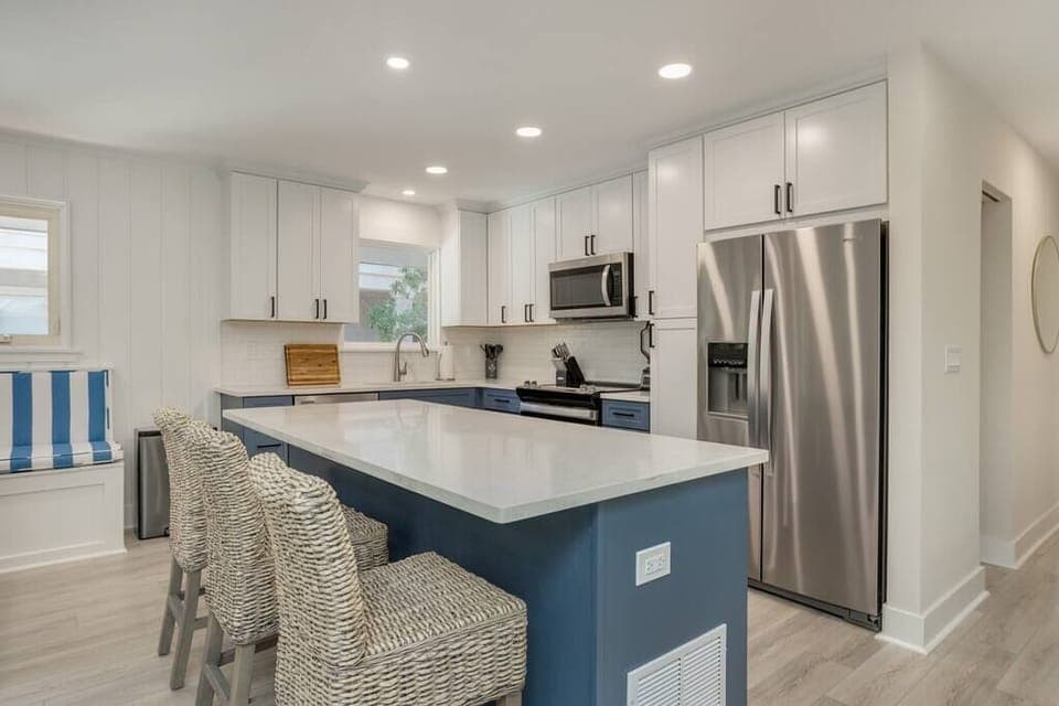 Full Kitchen with large island. Three bar stools. 
