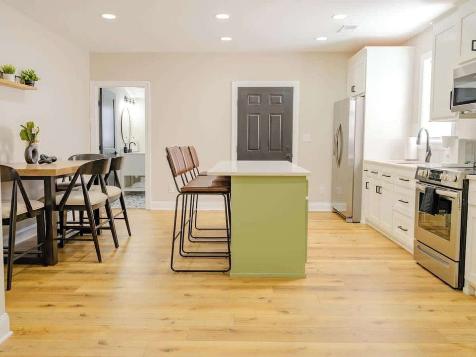 Kitchen, dining area, and downstairs half bath