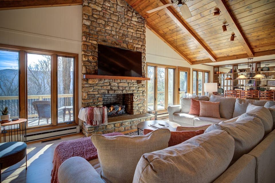 Living room with a gas fireplace, large couch and a smart TV!