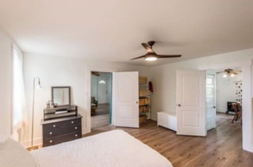 The master bedroom with view into dining room.