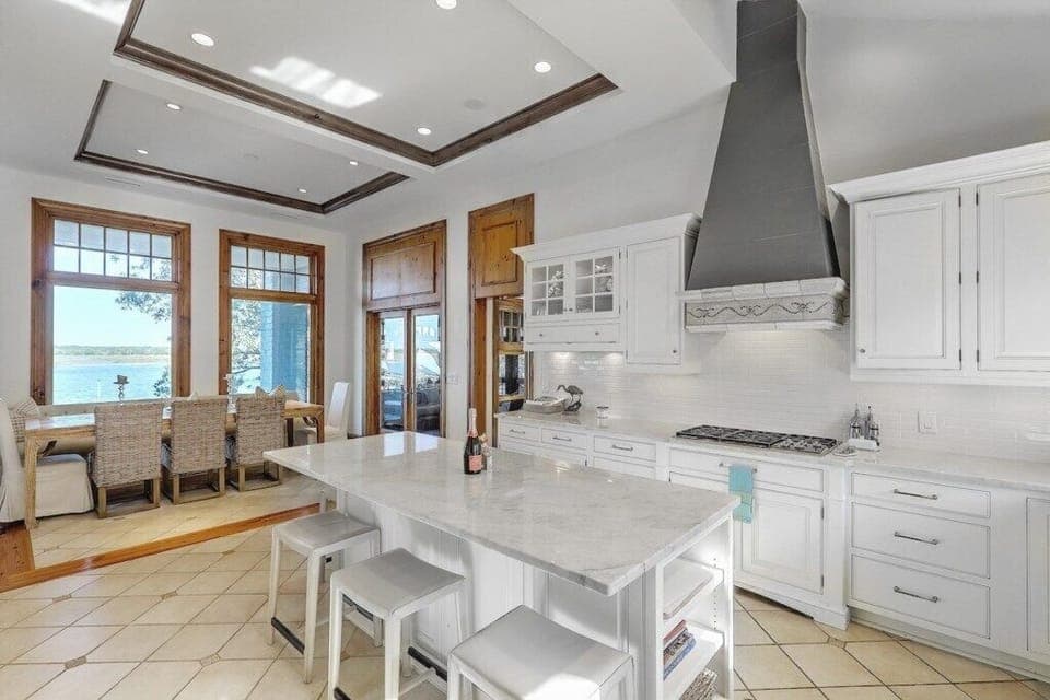 Modern kitchen featuring marble countertops and a spacious island, ideal for cooking and entertaining.