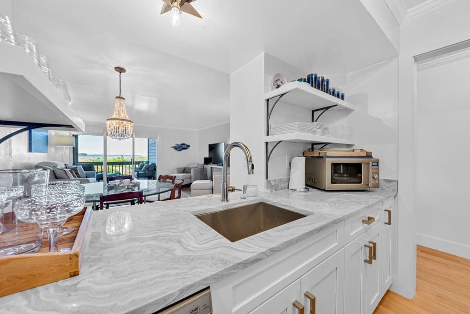 The kitchen pass through lets you look out to the great room and the ocean beyond the sliders!