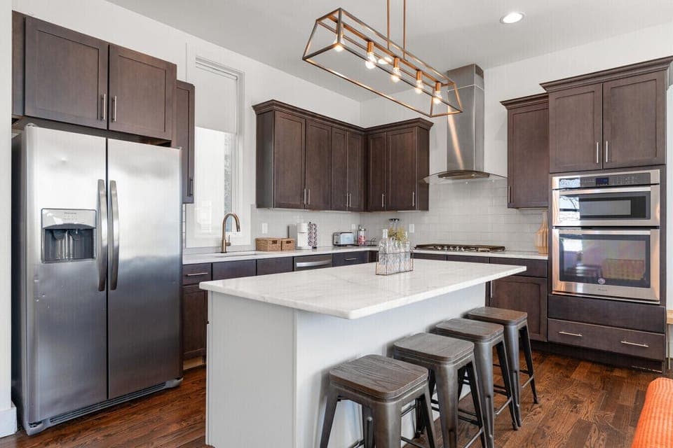 A gorgeous quartz island with bar seating — perfect for morning coffee, group breakfasts, or pregaming before you hit Broadway.
