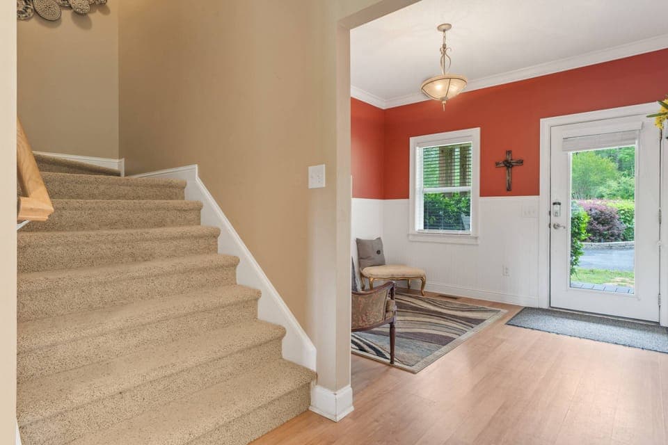 Stairway goes up to 4 bedrooms
