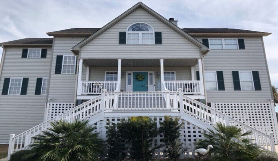 Front of House during the day.  3 story house.  Top 2 floors living area.