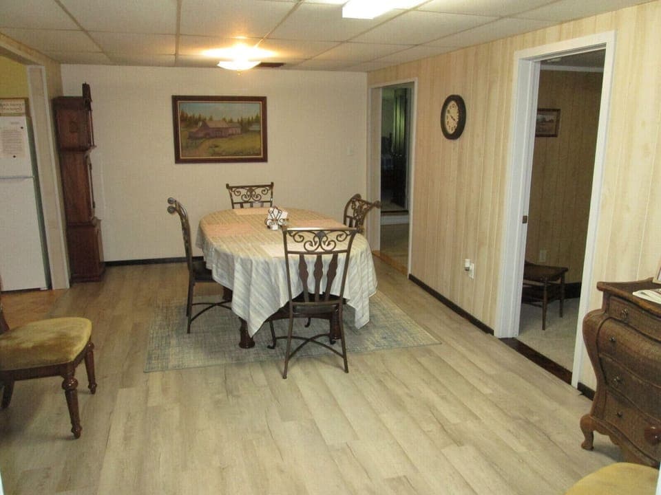 Dining area with view inside middle bedroom and walkway into office area, 