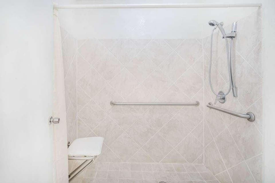 Bathroom with a shower and tub. The essential toiletries and towels are provided