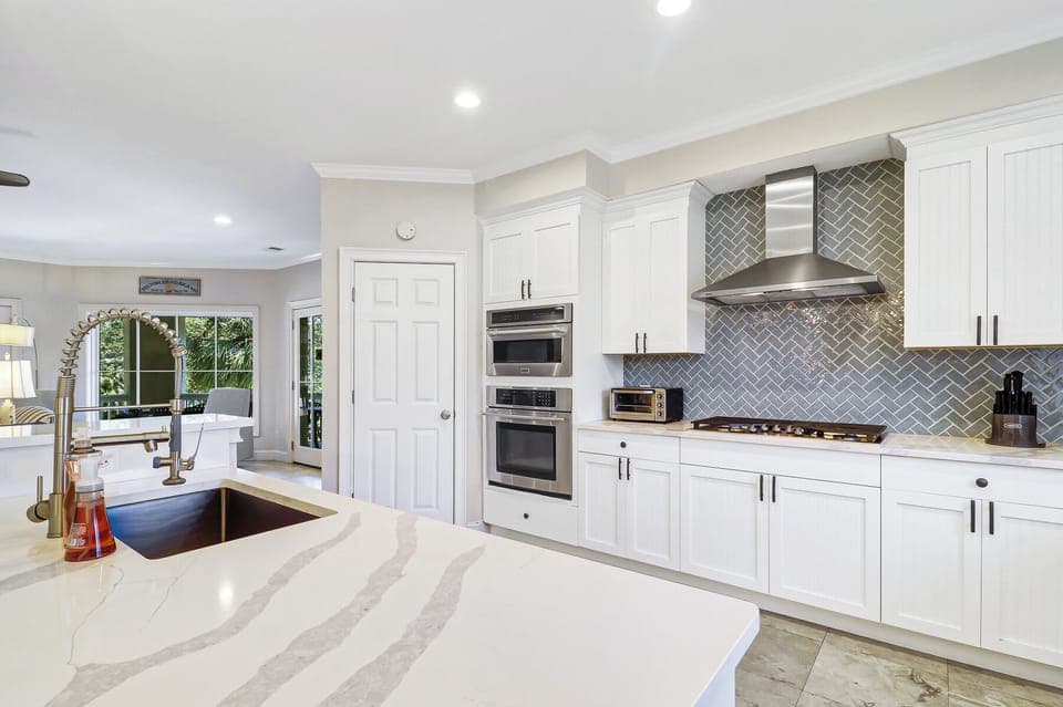 Bright, beautifully designed kitchen featuring sleek countertops, modern appliances, and an open layout that flows seamlessly into the living space - perfect for gathering and entertaining.