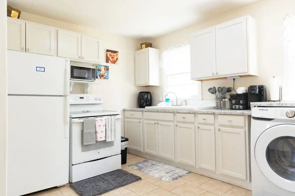 Kitchen: stove, fridge, microwave, k cup machine, air fryer, handheld blender.