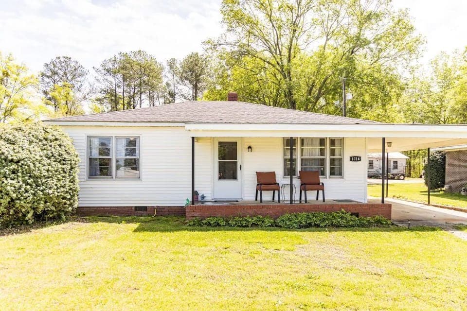 Front of house. Covered car port. Well lit driveway. 