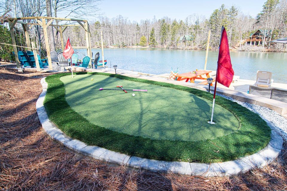 Putt your way to victory on this charming mini-golf green, complete with a lakeside view to enhance the play.