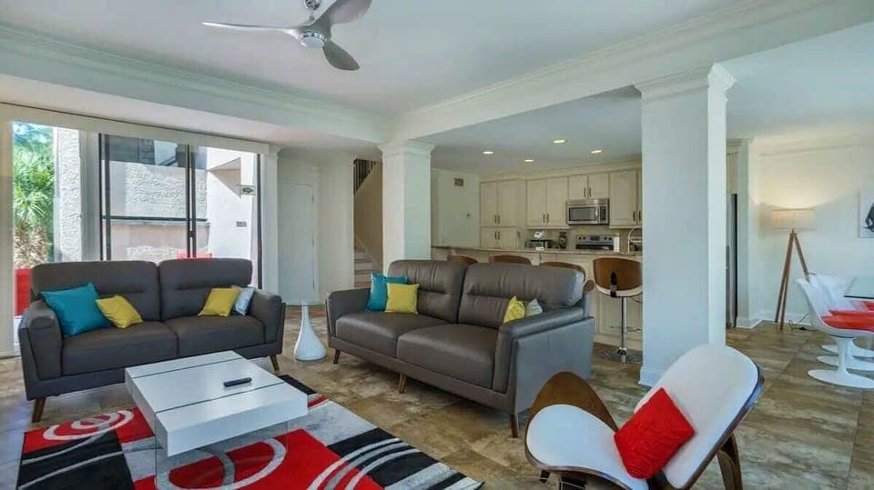 Bright & Airy Living Space - The open-concept living room features floor-to-ceiling windows, filling the space with natural light and offering beautiful views.