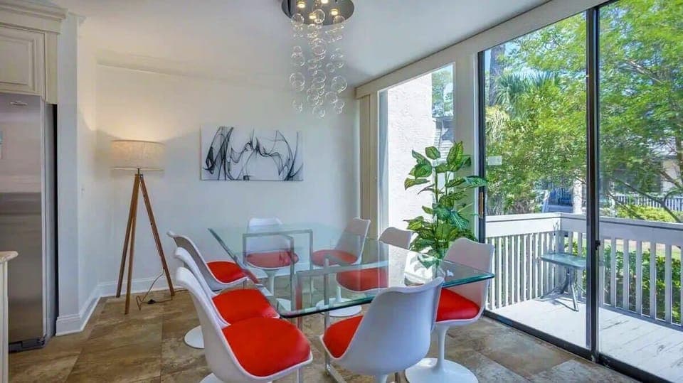Dining with a View - Gather around the elegant 8-seater dining table that opens up to the back deck, offering a seamless transition between indoor and outdoor dining.