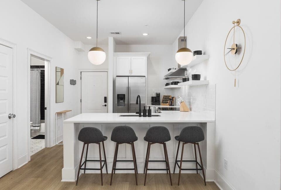 High-end appliances in the kitchen with seating for four at the counter! Fully stocked with all the utensils and cooking supplies you'll need for ease & convenience.