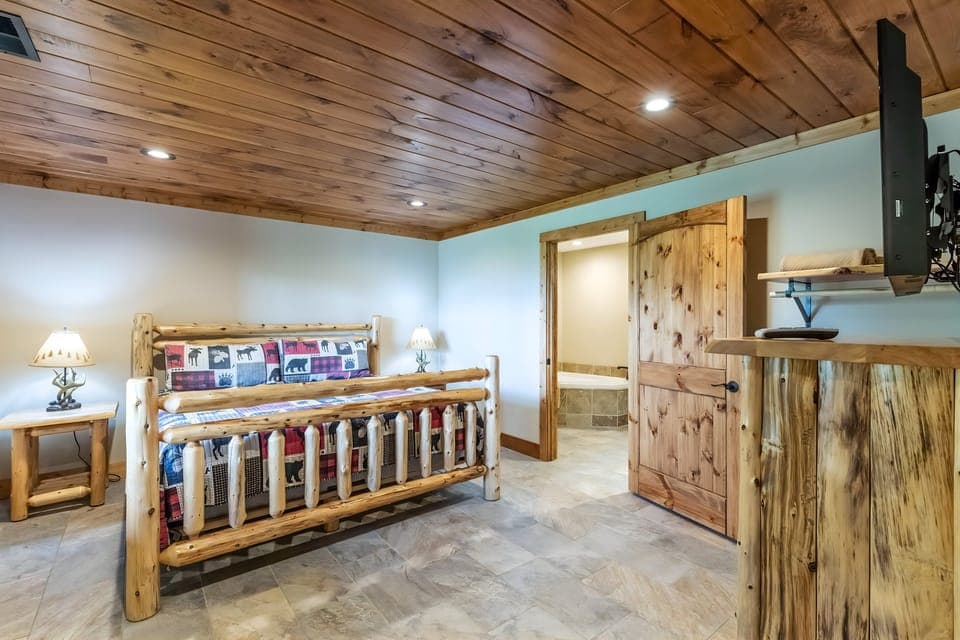 The lower level bedroom has a king-sized bed, an ensuite bathroom and personal TV.
