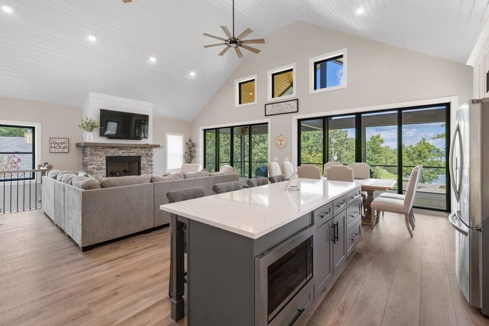 Open floor plan with kitchen, dining, and living area.  Take in views from the glass doors/windows
