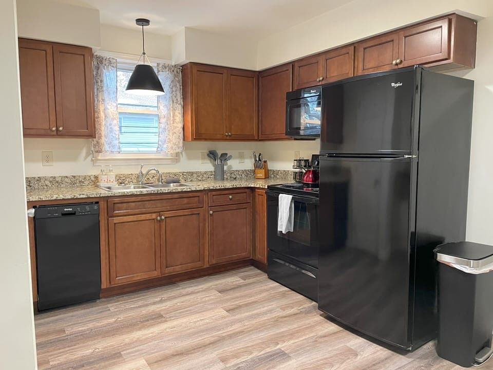 Full-sized kitchen with everything needed to prepare a meal and serve a meal. 