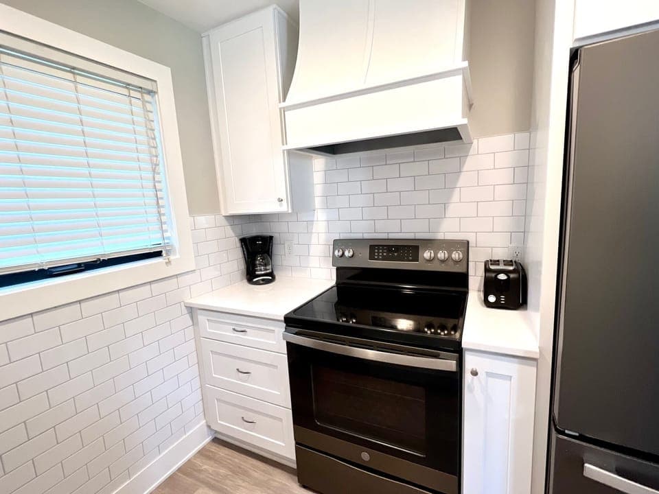 A clean, crisp kitchen with new appliances makes cooking a joy!