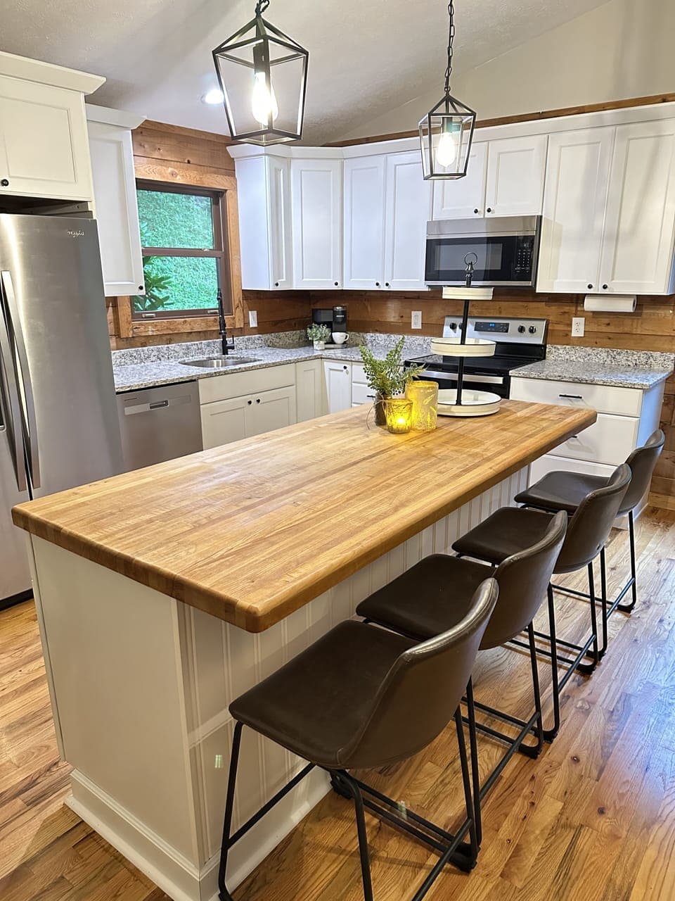 Renovated kitchen w/granite countertops & butcher block island  that seats 4.