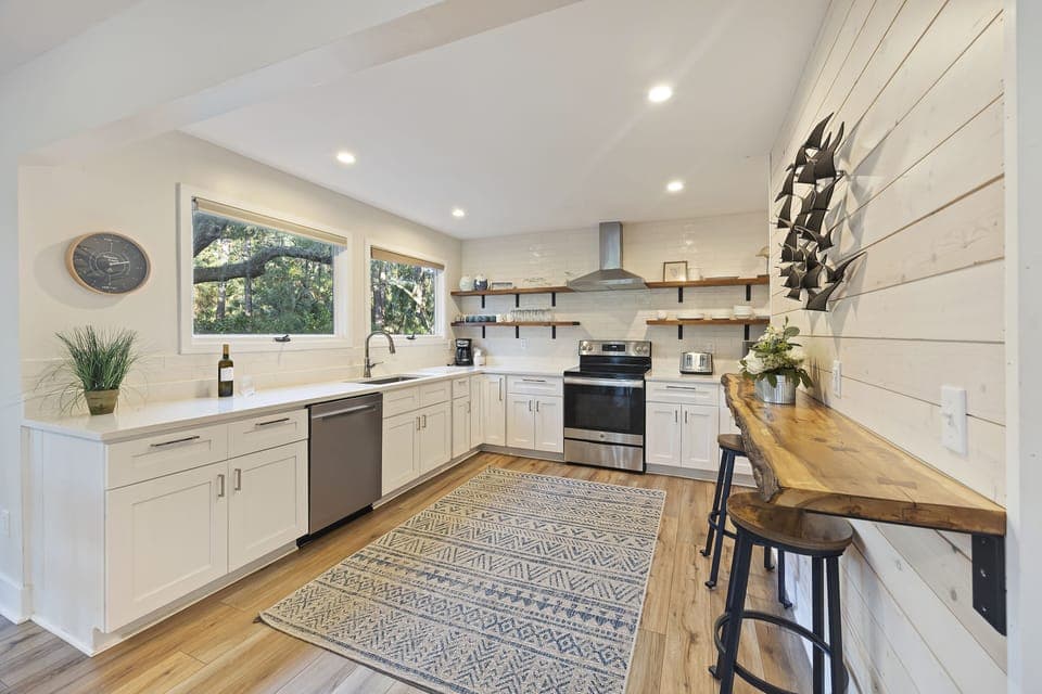 Beautiful kitchen with updated countertops, appliances, and modern open shelves.