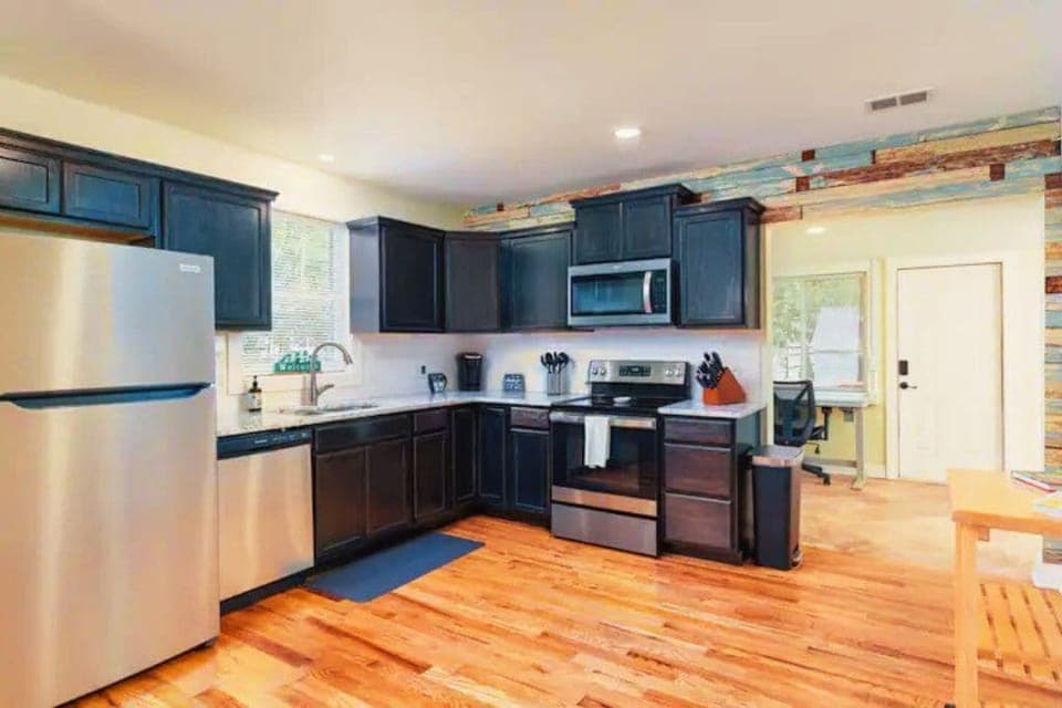 Full kitchen with dishwasher, microwave and stunning hardwoods. Electric stove.