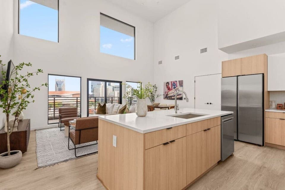 Spacious and grandiose living space with 20+ ft ceilings & many windows