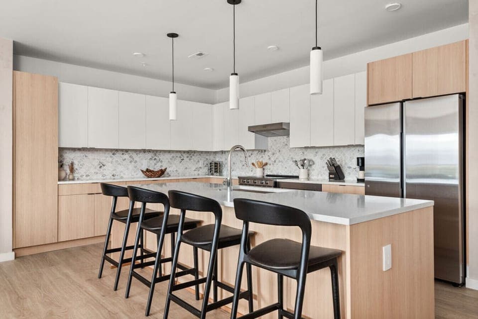 A fully equipped kitchen, stocked with coffee, tea, and condiments, along with a dining table to enjoy homemade meals.