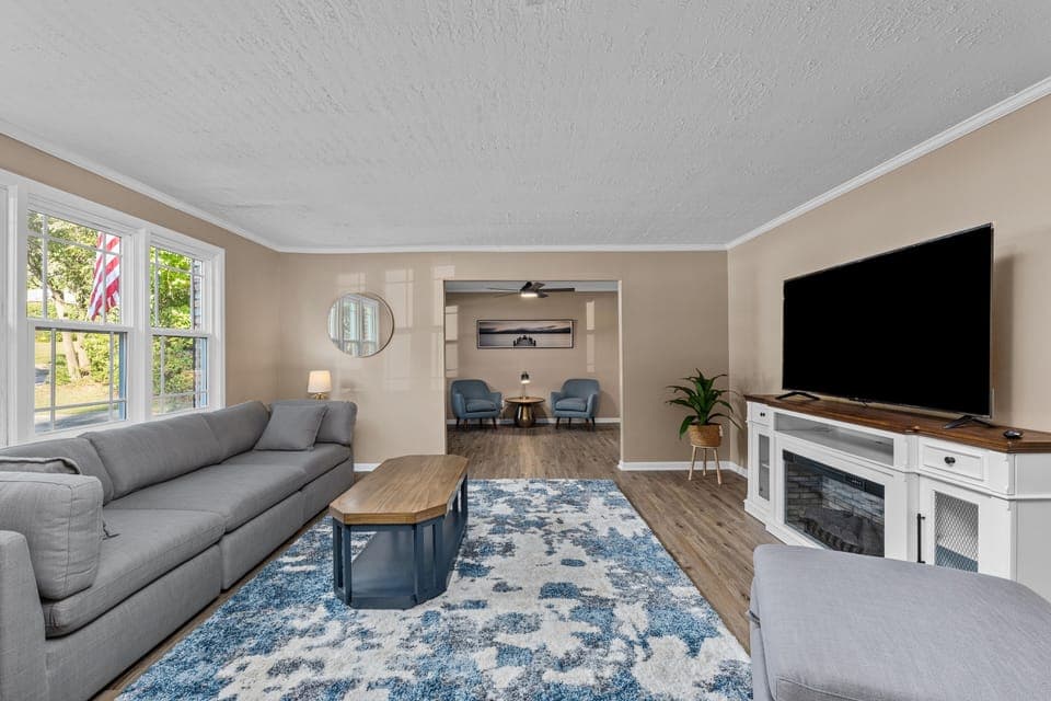 Living room with 65" smart TV and electric fireplace that heats entire room!